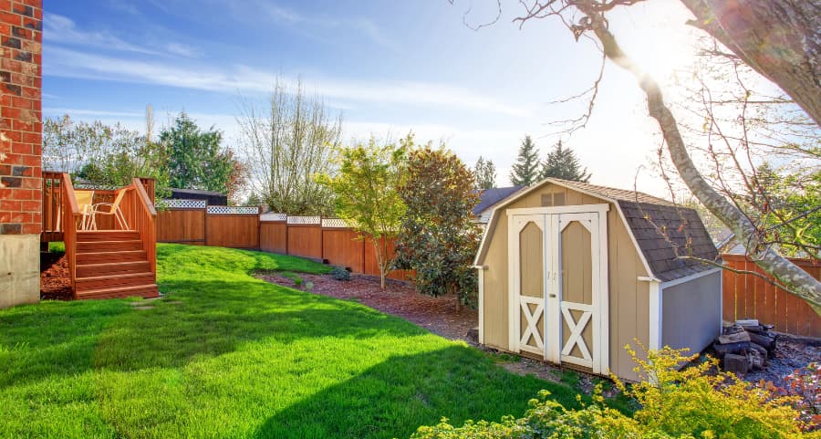 Fenced backyard with storage shed in Springfield